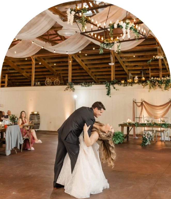 Couple dancing at decorated barn reception