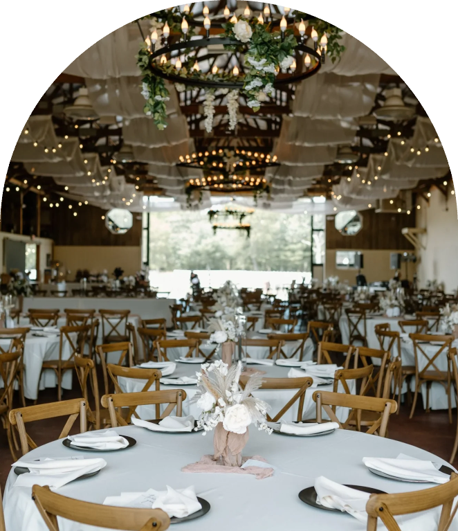 Barn reception tables set with floral centerpieces